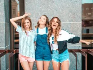 Three young girls smiling and laughing